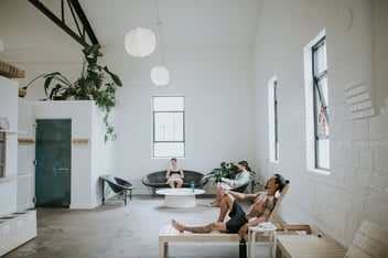 Image of people relaxing in Sauna House on heated furniture from Galanter & Jones